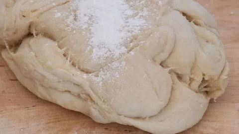 Mixing flour with egg, close-up, on a black background. Preparing the dough. Stock Footage 285422288