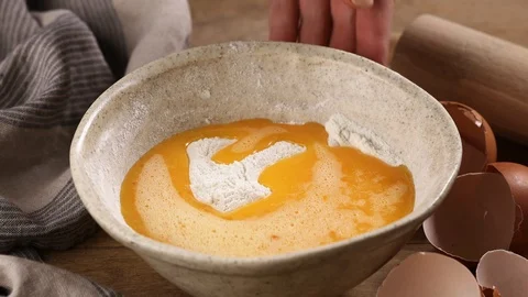 Mixing flour with eggs and sugar for making dough Stock Footage 101991659