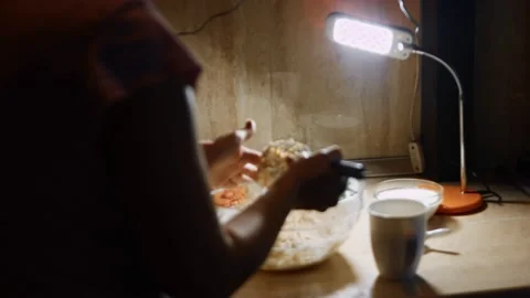 Mixing fresh eggs and flour and cleaning the steel hand mixer. Process of Stock Footage 144901458