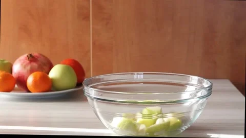 Mixing fresh fruit salad with apples,tangerines and persimmon. Stock Footage 144358440