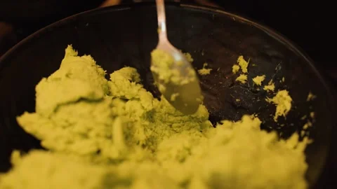 Mixing Fresh Wasabi Paste in Black Bowl with Spoon Stock Footage 323777718