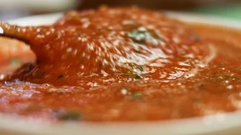 Mixing freshly made appetizing salsa in a bowl. Process of making salsa. Macro Stock Footage 151174791