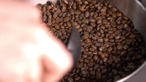 Mixing freshly roasted coffee beans Stockbeeldmateriaal 143663016