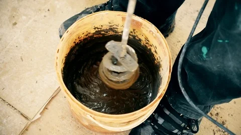 Mixing glue with a long drill Stock Footage 73852339