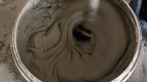 Mixing the glue solution in a bucket with a construction mixer Stock-Footage 317901748