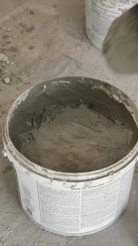 Mixing the glue solution in a bucket with a construction mixer Stock Footage 317902000