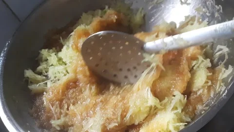 Mixing Grated Raw Mango into Sweet Mango Preserve on Stove Video stock 335811291