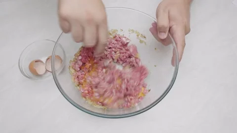Mixing Ground Meat And Eggs By Hand Top View 動画素材 332809972