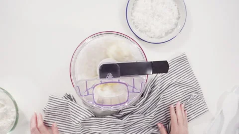 Mixing ingredients in a food processor to prepare homemade coconut cookies. Stock Footage 157627410