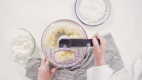  Mixing ingredients in a food processor to prepare homemade coconut cookies. Stock Footage 157627799