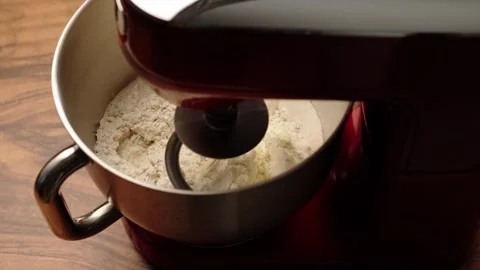 Mixing ingredients for making homemade bread in a planetary mixer, slow motion Stock Footage 281460310