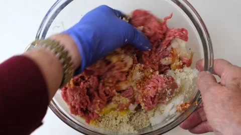 Mixing ingredients for meatloaf Stock Footage 219492873