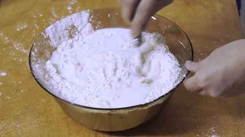 Mixing ingredients when kneading dough Stock Footage 72896776