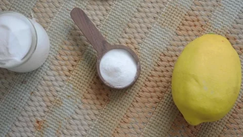 Mixing lemon and baking soda for cleaning in kitchen Stock Footage 337285119