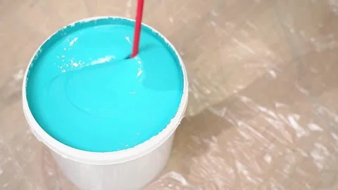 Mixing light blue paint in white bucket Stock Footage 308018098