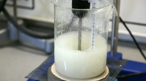 Mixing liquid in beaker Stock Footage 24652701