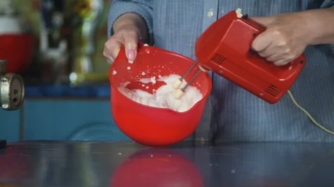 Mixing liquid dough for baking using an electric mixer. Cooking cake. Stock Footage 128829407