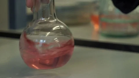 Mixing the liquid in the flask Stock Footage 81696612