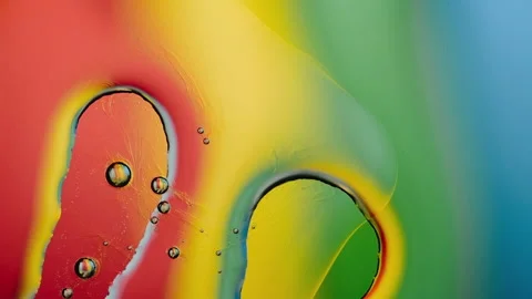 Mixing liquids of different density against the background of iridescent ligh Stock Footage 142730366