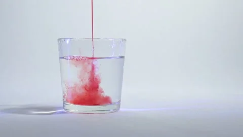 Mixing of liquids in a glass or dissolution 1 Stock Footage 99729431
