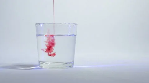 Mixing of liquids in a glass or dissolution 4 Stock Footage 99730713