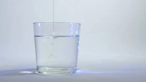 Mixing of liquids in a glass or dissolution 7 Stock Footage 99733683