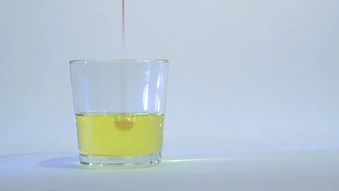 Mixing of liquids in a glass or dissolution 12 Stock Footage 99736746