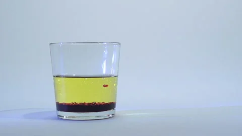 Mixing of liquids in a glass or dissolution 14 Stock Footage 99738635