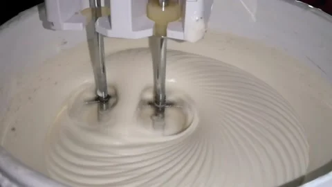 The mixing machine is rotating mixing the cream batter Stock Footage 153640655