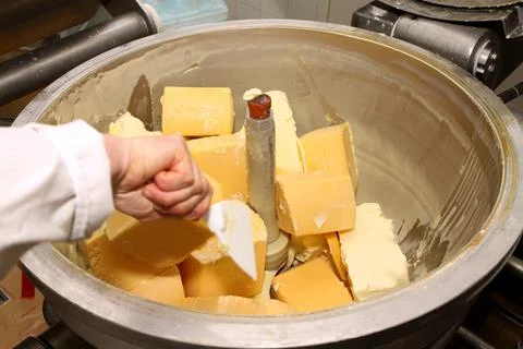Mixing mass for the production of processed cheese. Cheese production Stock Photos