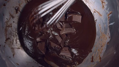 Mixing melted liquid dark chocolate and chocolate pieces Stock Footage 123311279