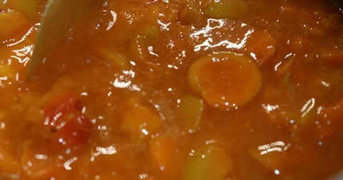 Mixing in a metal pot while cooking apricot marmalade Stock Footage 112130925