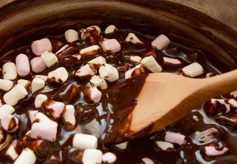 Mixing mini marshmallows into dark chocolate Stock Photos