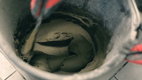 Mixing mortar in a bucket Stock Footage 95851917