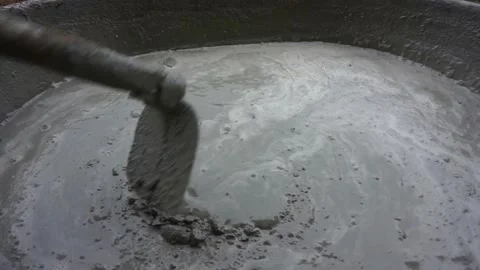 Mixing mortar for pouring concrete in front of the house Stock Footage 163582407