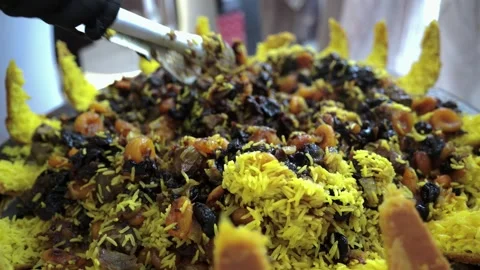 Mixing opened pilaf with Dried Apricots and Prunes Stock Footage 321704773