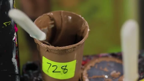 Mixing paint. Brown screen printing ink with person's hand Stock Footage 139387371