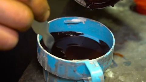 Mixing of paint in a container Stock Footage 80929776