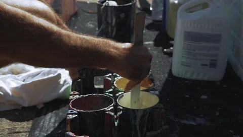 Mixing paint on the sidewalk Stock Footage 74589744