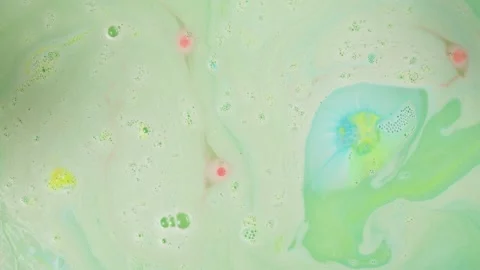 Mixing paints close-up, dissolved bath bomb. Decorative cosmetic products for Stock Footage 166314248