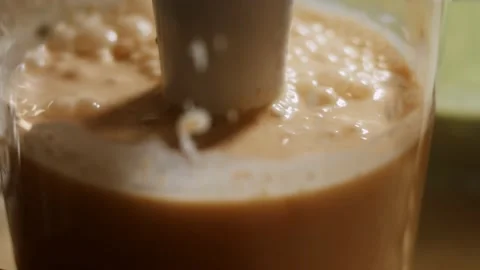 Mixing pancake batter and rubbed carrrot with a hand blender. Process of Stock Footage 144903822