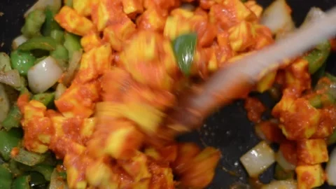 Mixing the Paneer into the Veggies Stock Footage 136059451