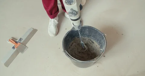 Mixing plaster solution in a bucket Stock Footage 113118927
