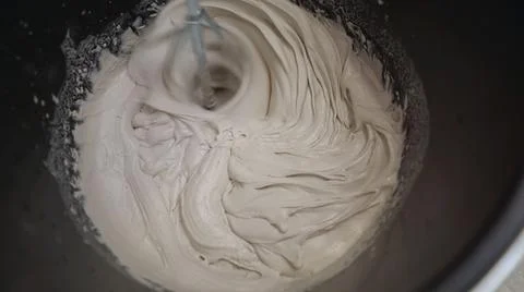 Mixing plaster solution in a bucket, using an electric drill. Mixing beige putty Stock Photos