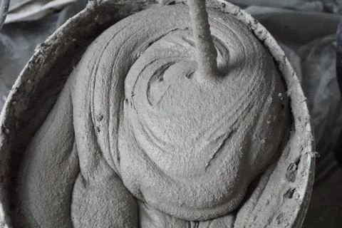 Mixing of a plaster solution by an electric drill. Home renovation Stock Photos