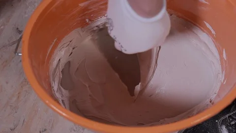 Mixing Of A Plaster Solution By Manual Method. Professional Builder Stock Footage 101382852