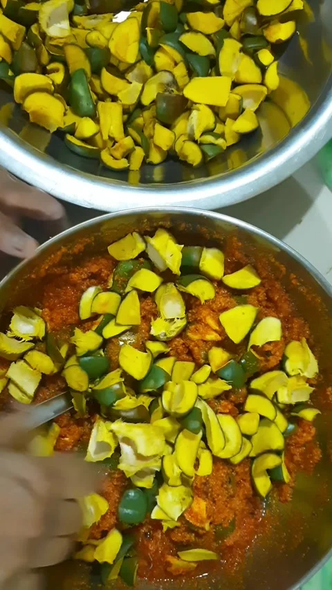 Mixing Prepared Mango Chunks into Spiced Seasoning Blend 스톡 동영상 337772155