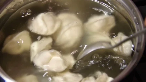 Mixing preparing dumplings in the pan Stock Footage 82832198