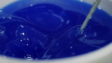 Mixing process of blue epoxy resin mixers to produce epoxy wood tables Stock Footage 152724678