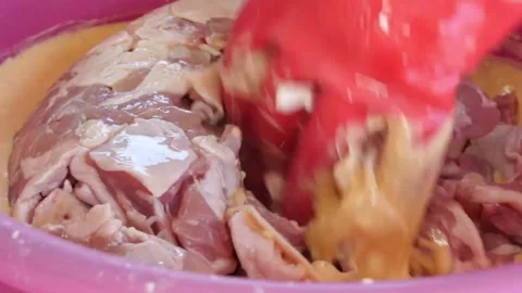 Mixing Raw Chicken Thighs in Batter with Spatula 스톡 동영상 343587847